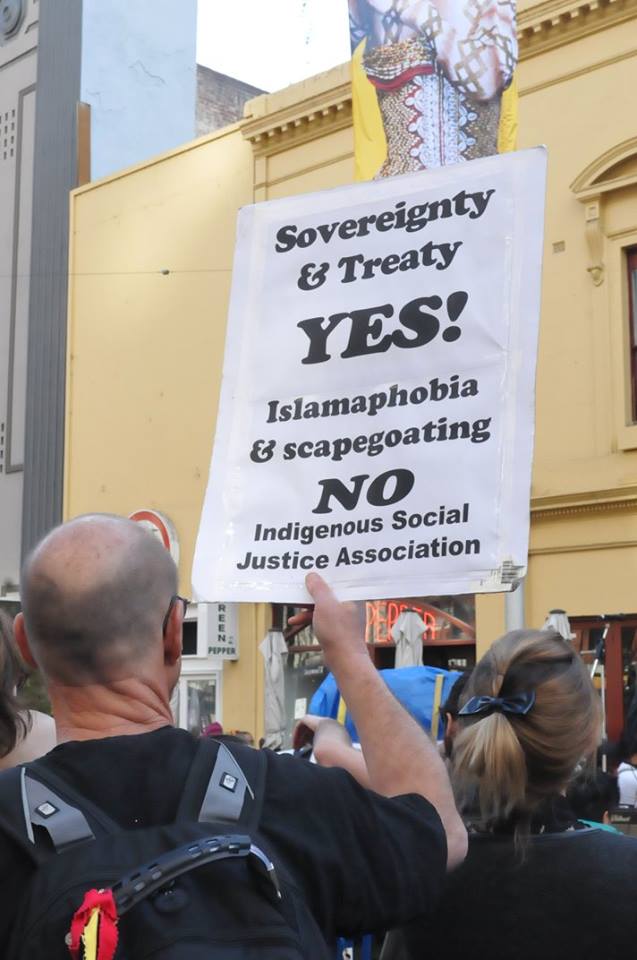 Placard says: Sovereignty & Treay Yes! Islamophobia & Scapegoating No.