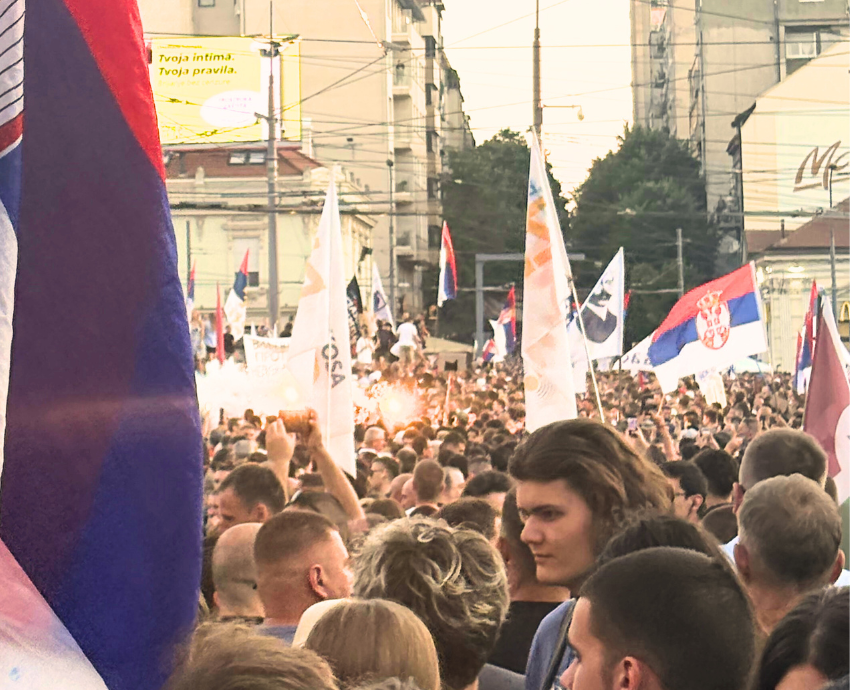 crowds of protesters in a square in Belgrade