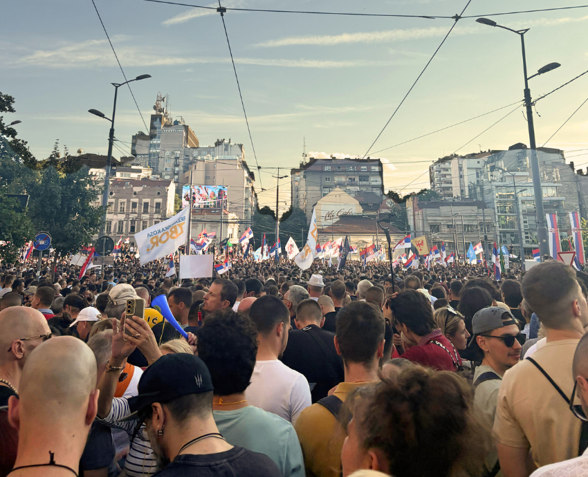 crowds of protesters in a square in Belgrade
