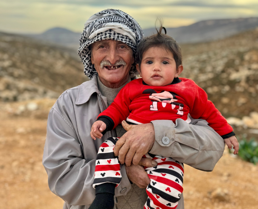 Palestinian man holding a child