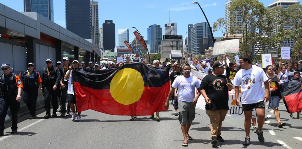 Aborignal flag at G20 protests Brisbane 2014.
