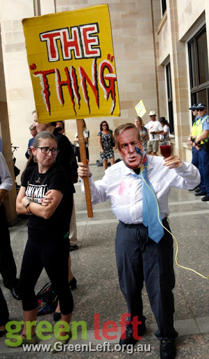 Protester in Barnett costume and placard