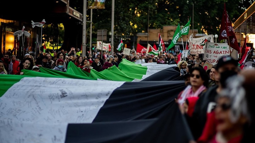 Protesters carry giant Palestinian flag, Gadigal Country/Sydney Protesters carry giant Palestinian flag, Gadigal Country/Sydney