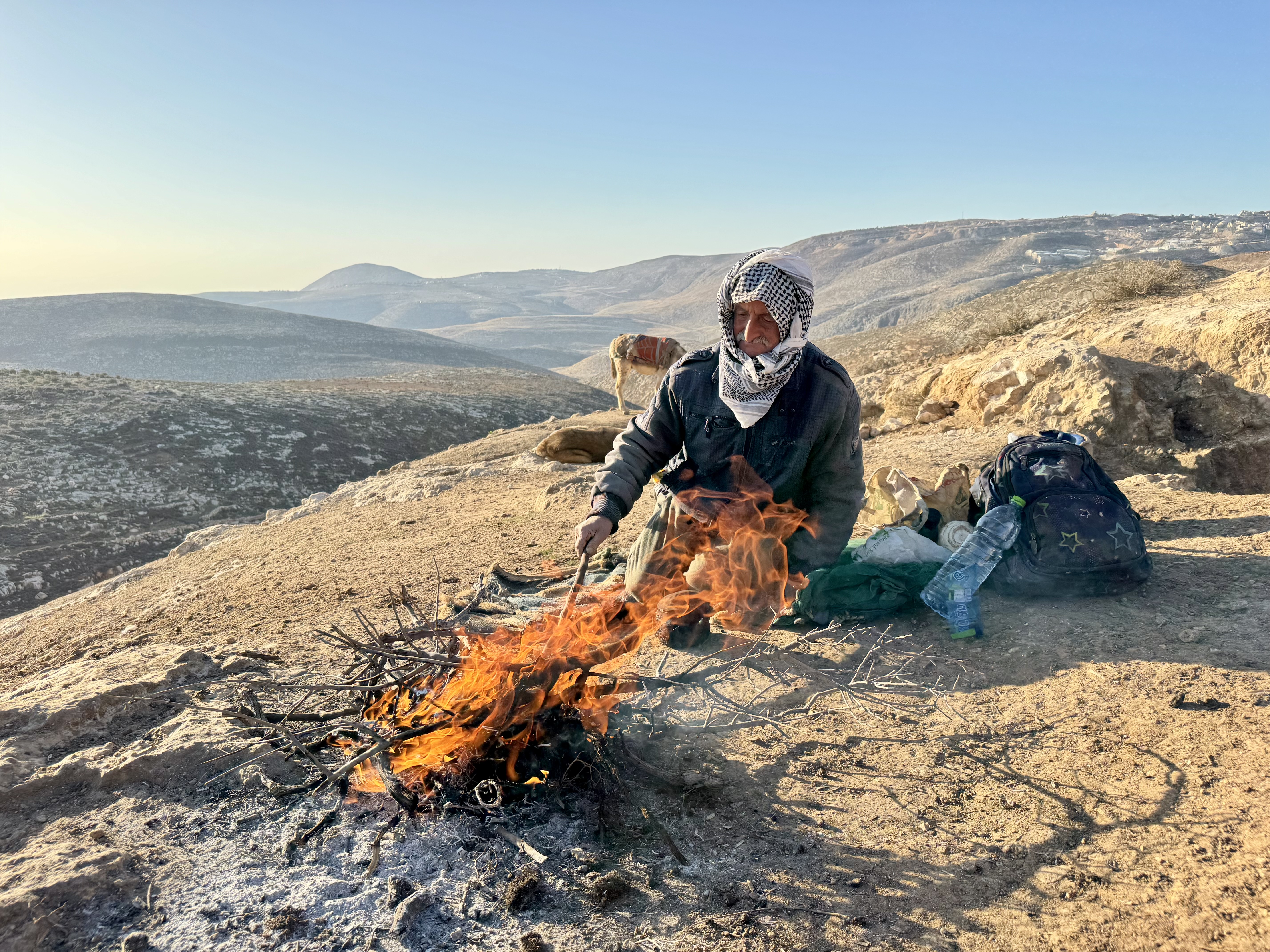 Palestinian man making a fire