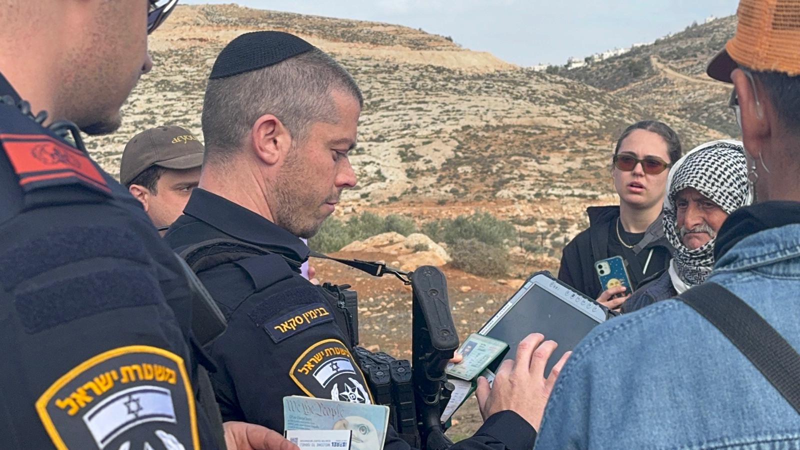 Israeli soldiers and police with Palestinian villagers and ISM witnesses