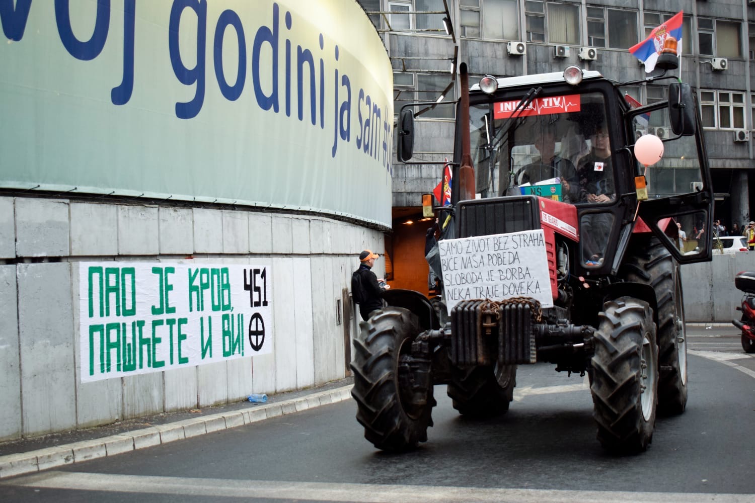 tractor next to a wall with graffiti