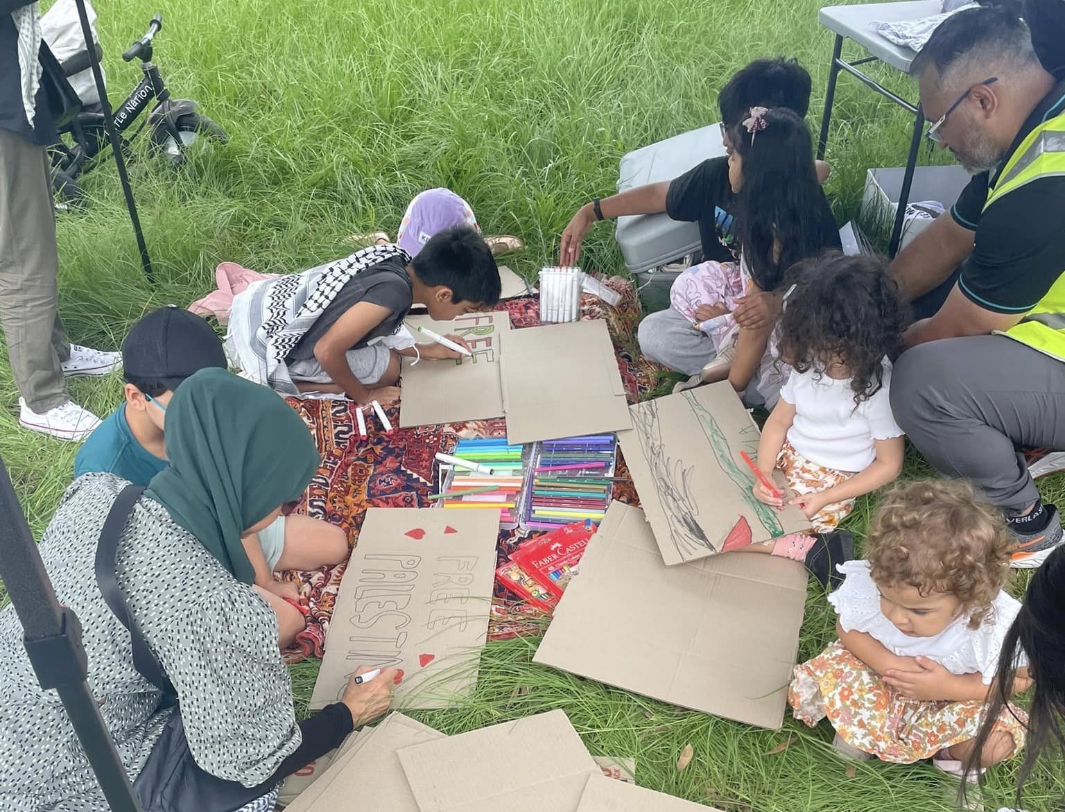 Children making placards at Rowan Park