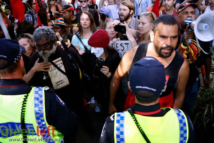 Police hold back the protesters