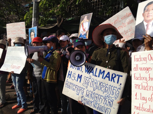 Protesting garment workers occupying street outside the factory in Phnom Penh that owes then unpaid wages.