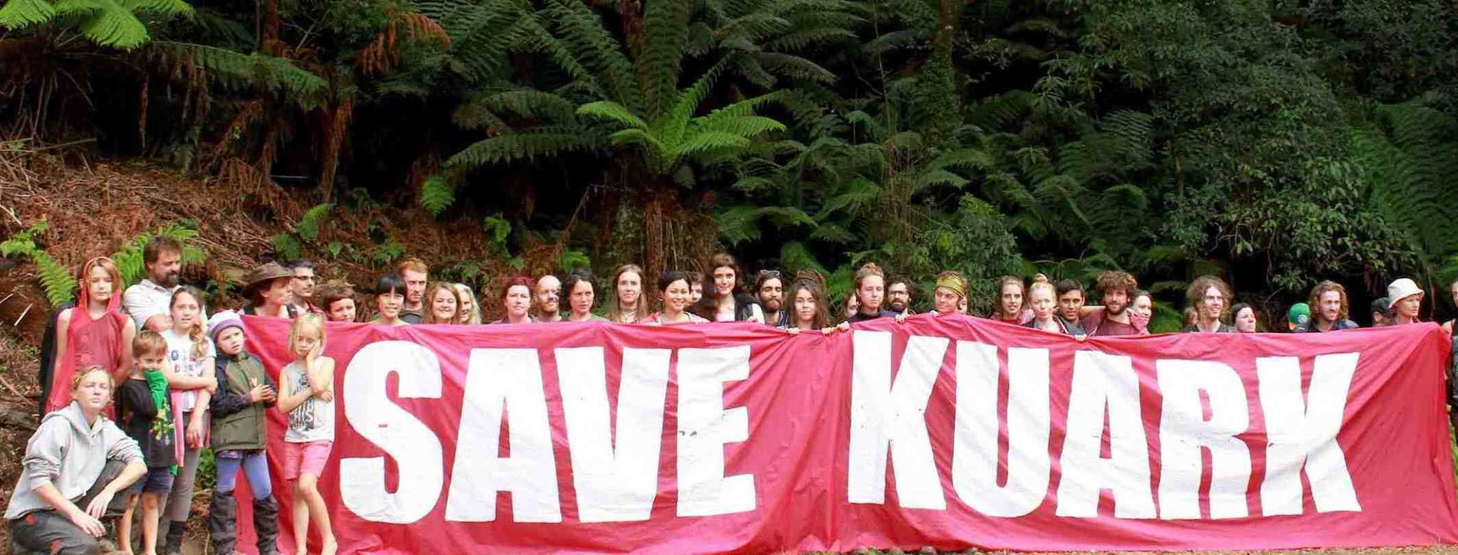 Save Kuark banner and protesters