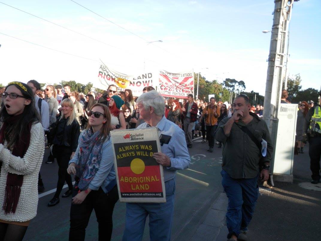 Protester holding Socialist Alliance placard at the rally.