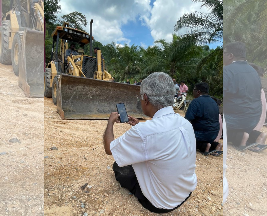 protester in front of bulldozer