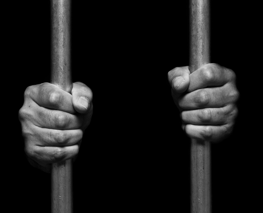 hands behind bars