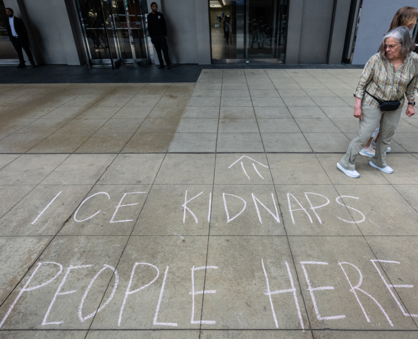 Chalk on a footpath says 'ICE kidnaps people here'