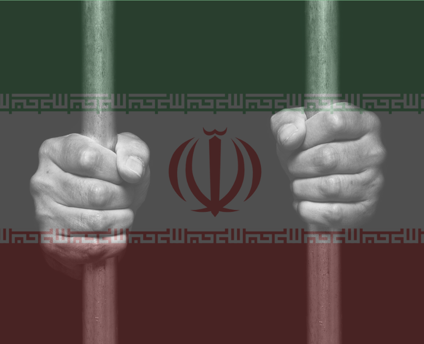 Iranian flag behind a prisoner in a cell