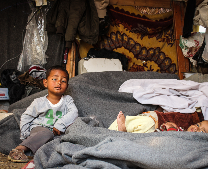 Young children in a tent in the Global South