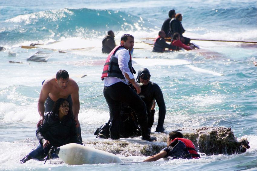 Local residents and rescue workers help migrants from the sea after a boat carrying them sank off the island of Rhodes, Greece, in April 2015.