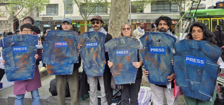 people holding press vests