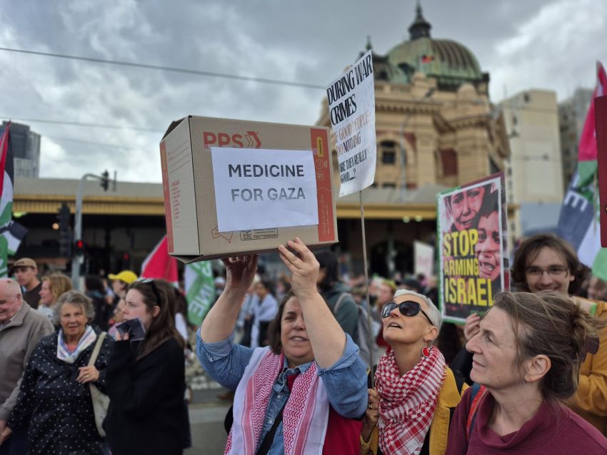 woman holding box that says medicine for Gaza