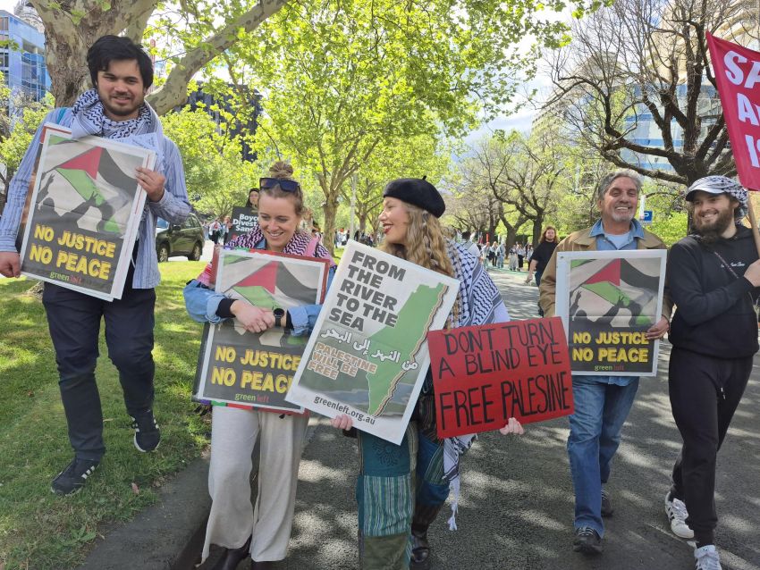 people holding Green Left posters