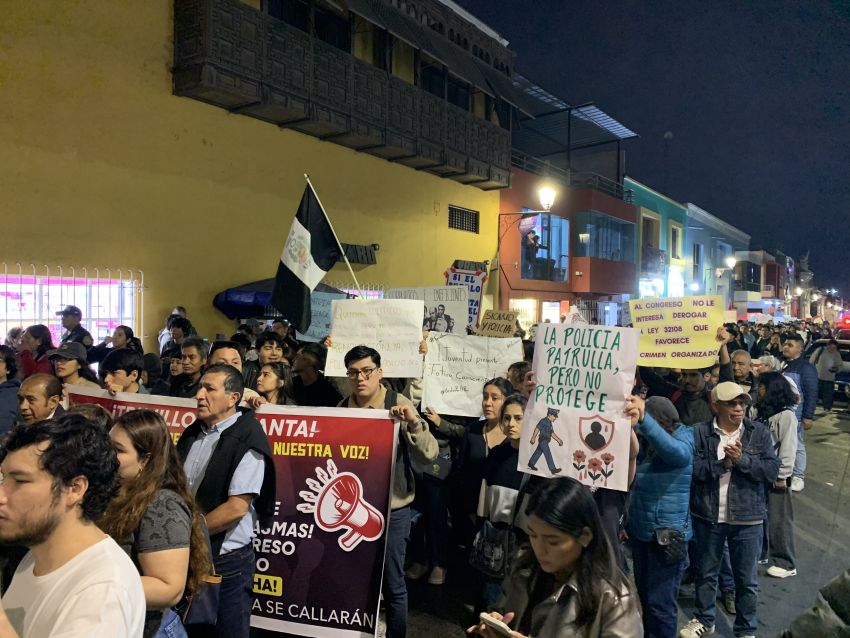 Protesters carry a sign that reads: 'Police patrol but don't protect'