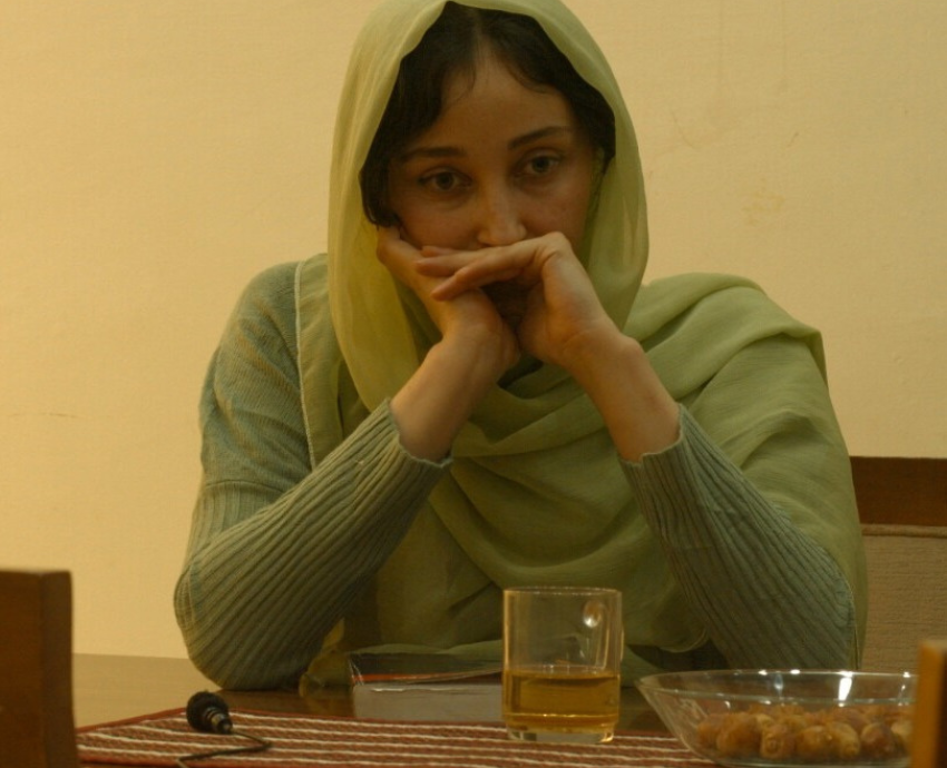 Woman in a head scarf at a table