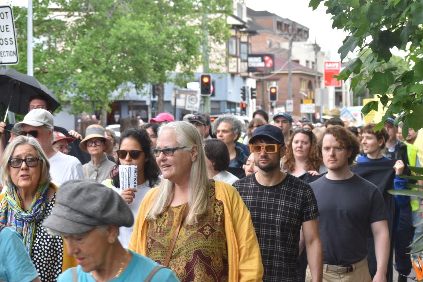 crowd marching through marrickville