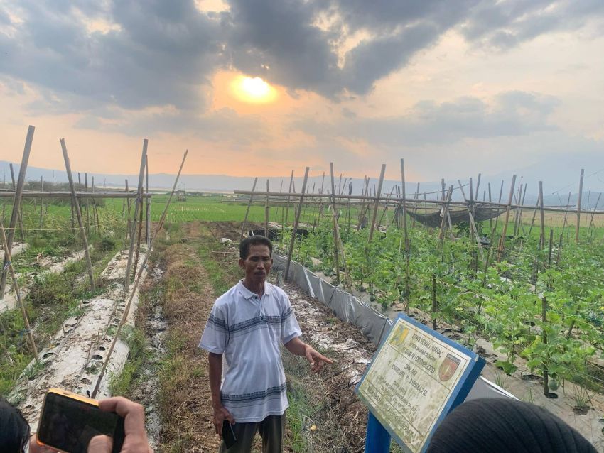 Person standing next to a sign at Lake Rawa Pening in Indonesia