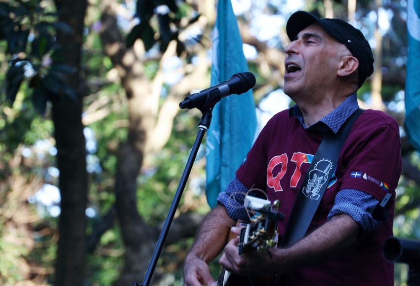 QTU member, Phil Monsour, singing at the rally