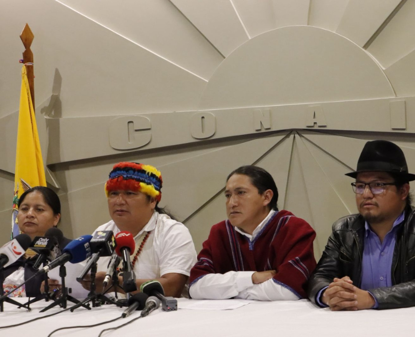 Four people speaking to a media conference