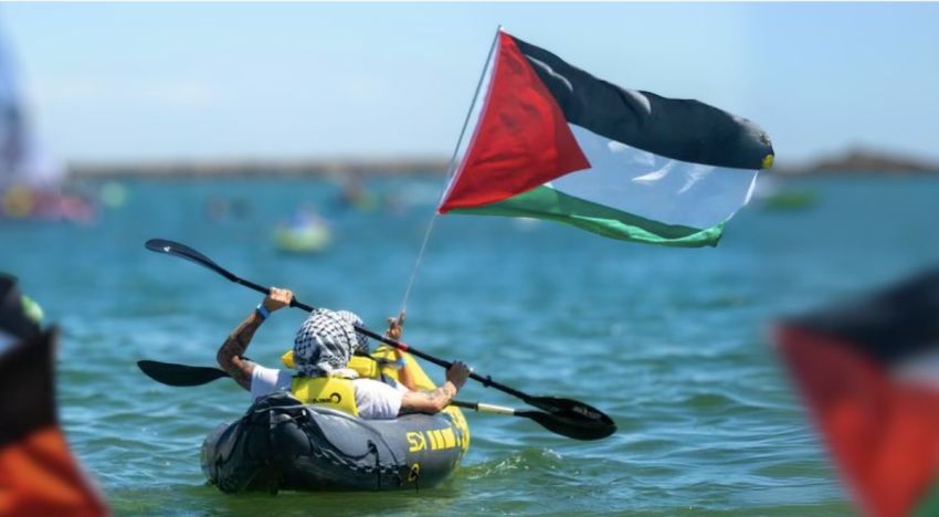 Cropped photo of Palestine solidarity activist kayaking at Rising Ride blockade