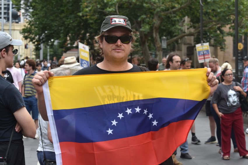 man holding venezuelan flag