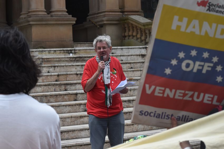 man speaking on town hall steps