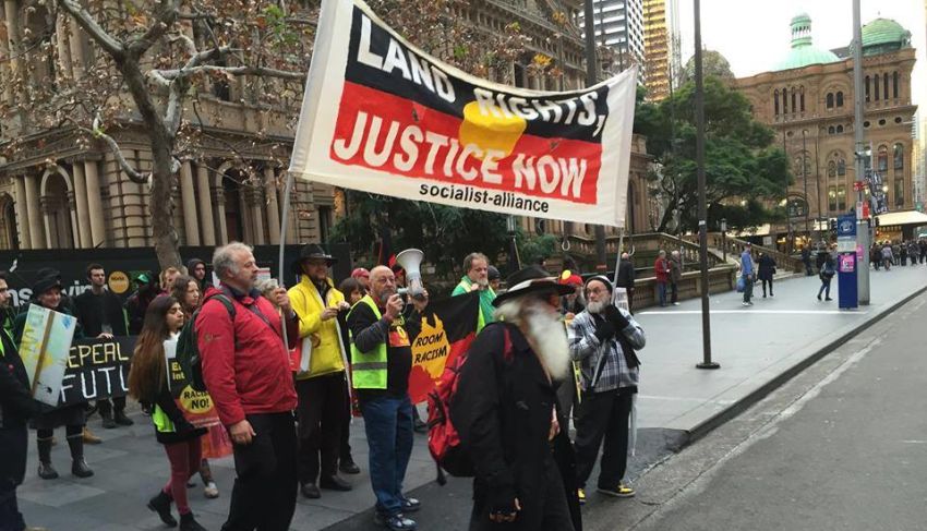 Cropped photo of Socialist Alliance supporters holding a Land Rights Justice Now banner near Sydney Town Hall