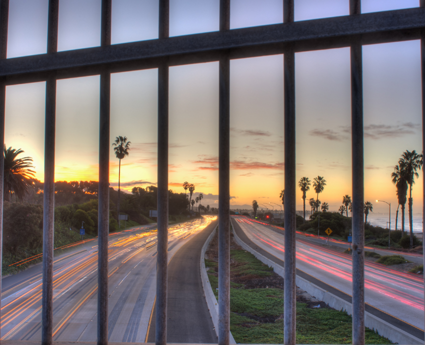 View of a highway from behind a fence