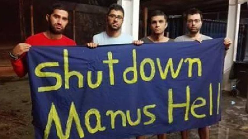 Photo of people holding a banner that has Shut down Manus Hell printed on it