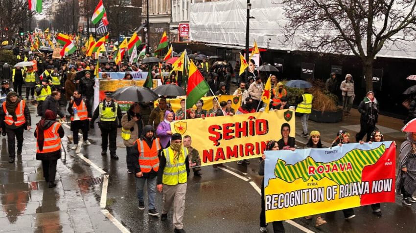 Protesters holding signs and banners and marching in London