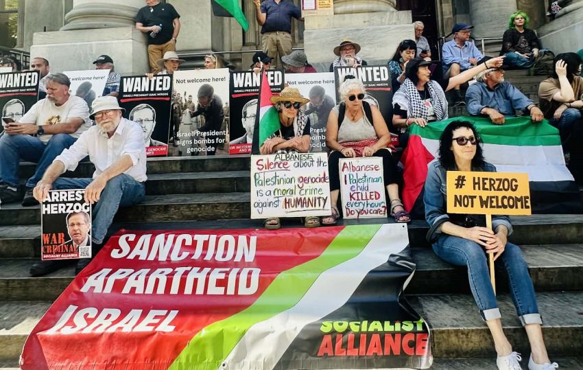 protest on the steps of parliament house in adelaide against israels president isaac herzog, with a large socialist alliance banner in front