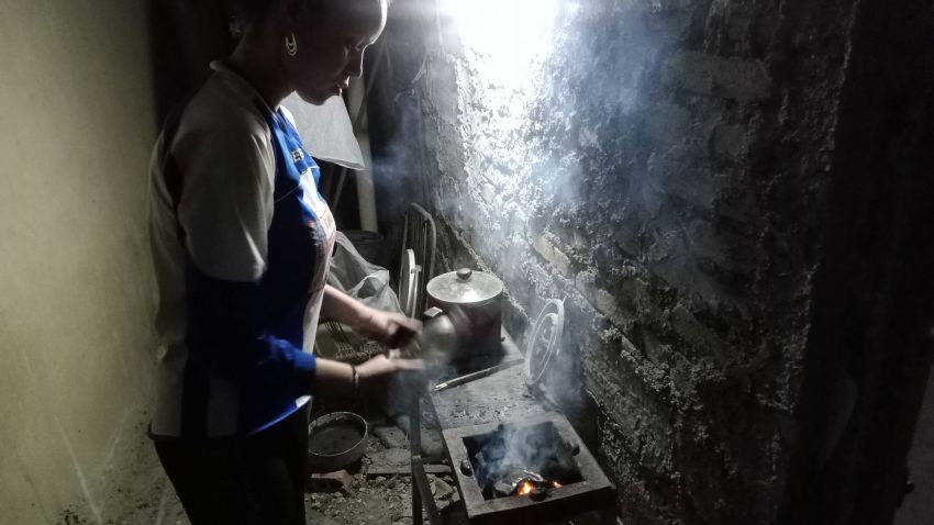 Cuban woman cooks with charcoal