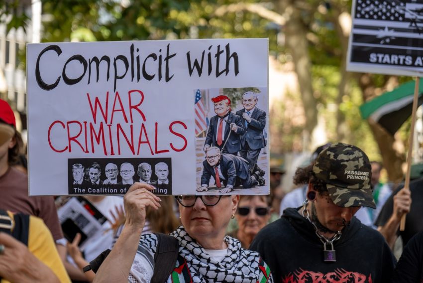 sign from a protest in Sydney against the war on Iran reading: 'complicit with war criminals'