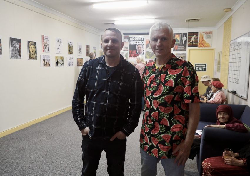 Two men at an art exhibition