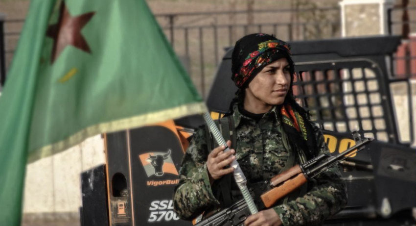 YPJ fighter carrying a flag