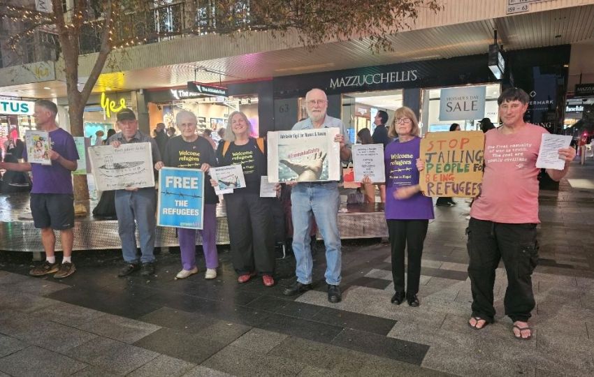 Supporters of the Adelaide Vigil for Manus and Nauru in Rundle Mall holding signs and placards supporting refugees.