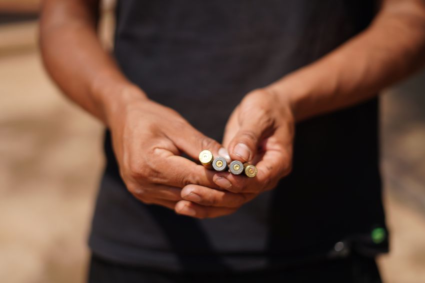 person holding bullet casings