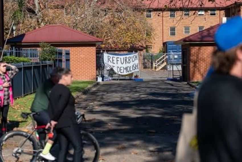 Photo of protestors at the Save Waterloo Encampment with a banner in the background that has Refurbish Don't Demolish printed on it