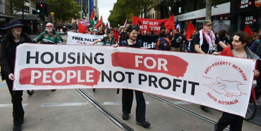 Anti-Poverty Network SA members and supporter with housing banner at protest