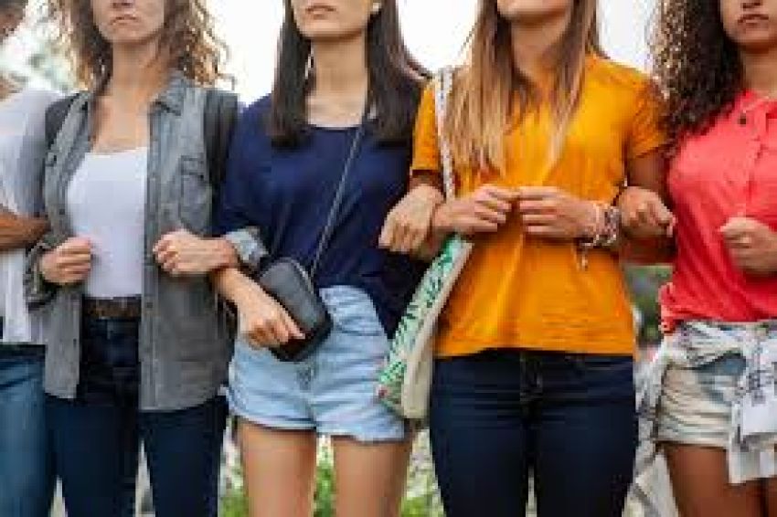 A photo of people standing together with their arms linked