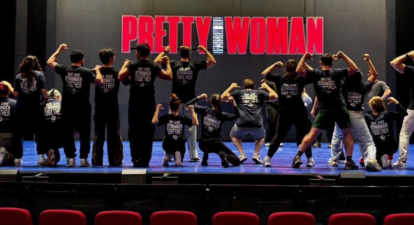 A cropped photo of MEAA members wearing MEAA t-shirts on a stage