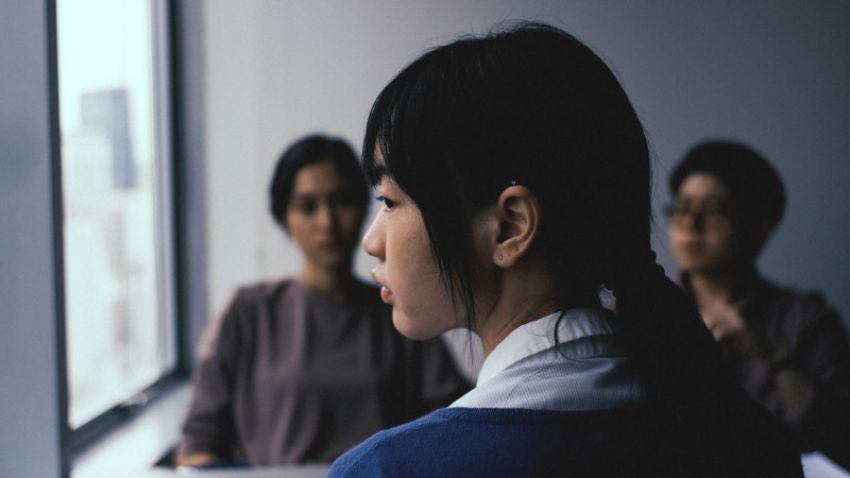 woman looking out a window