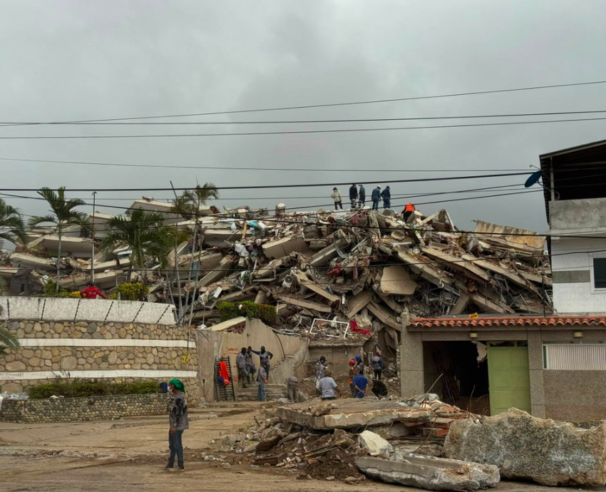 people standing on top of building rubble